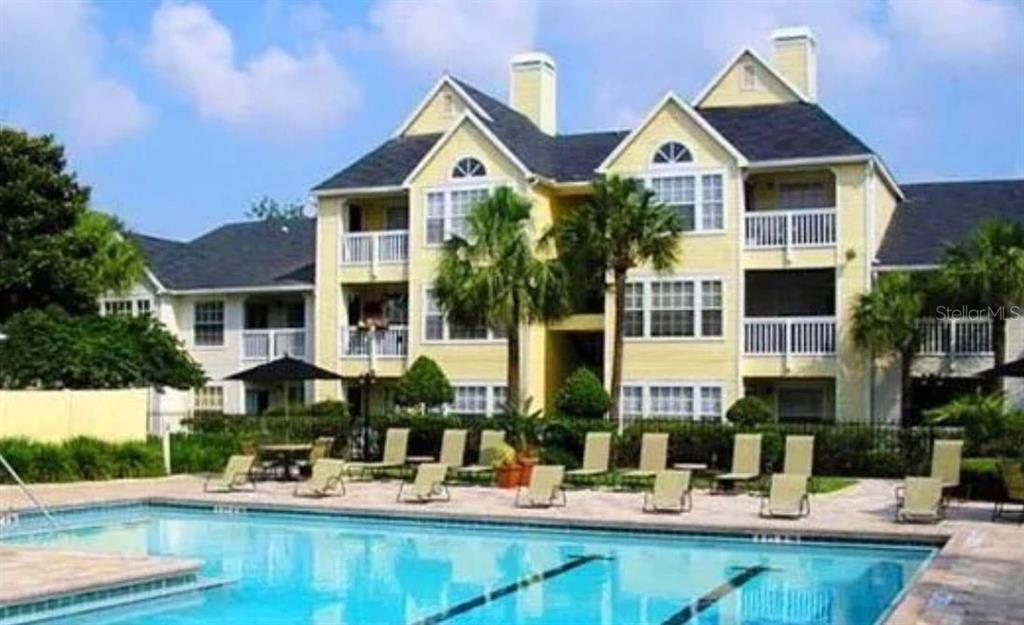 1087 South Hiawassee Road, Unit 422 Orlando, FL 32835 - Photo 1 of 17 a front view of a house with swimming pool and glass windows