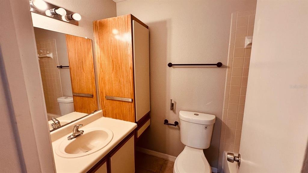 1087 South Hiawassee Road, Unit 422 Orlando, FL 32835 - Photo 12 of 17 a bathroom with a sink toilet and shower