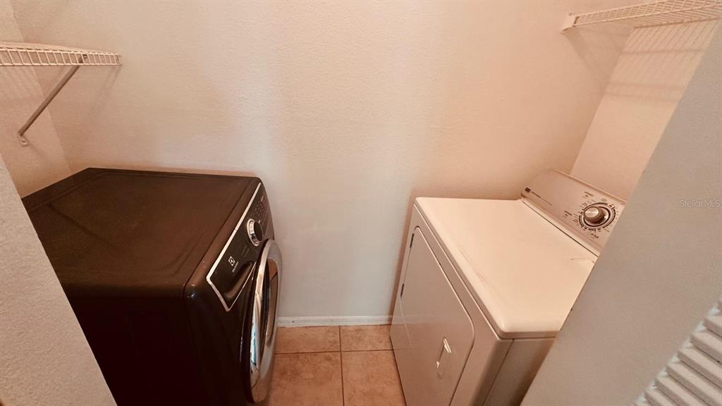 1087 South Hiawassee Road, Unit 422 Orlando, FL 32835 - Photo 14 of 17 a utility room with dryer and washer
