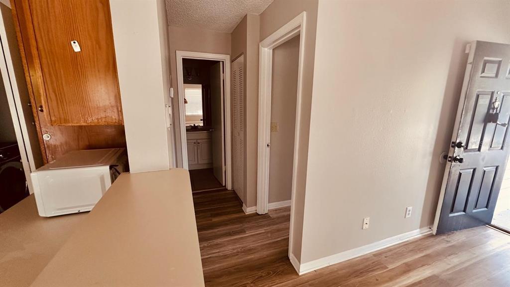 1087 South Hiawassee Road, Unit 422 Orlando, FL 32835 - Photo 6 of 17 a view of a hallway with wooden floor and stairs