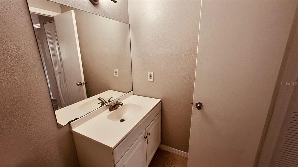 1087 South Hiawassee Road, Unit 422 Orlando, FL 32835 - Photo 9 of 17 a bathroom with a sink and a mirror