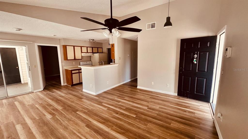 1087 South Hiawassee Road, Unit 422 Orlando, FL 32835 - Photo 10 of 17 a view of a kitchen with a stove cabinets and wooden floor