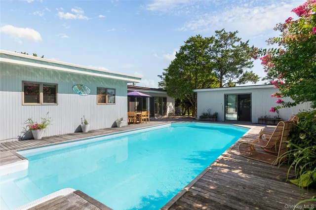 a front view of house with yard barbeque oven and outdoor seating