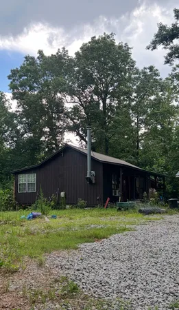 a front view of house with a garden