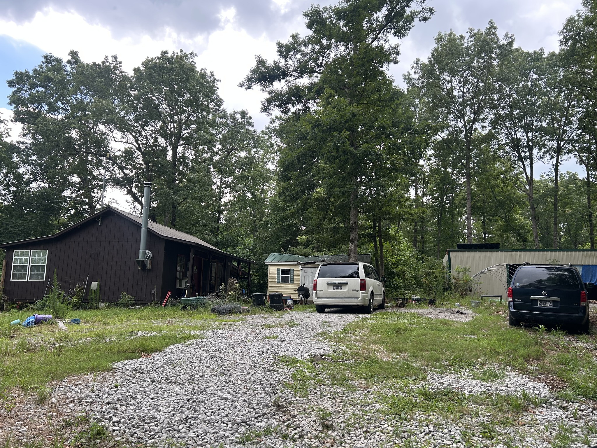 170 Deer Run Loop Altamont, TN 37301 - Photo 3 of 19 a front view of a house with a garden and trees