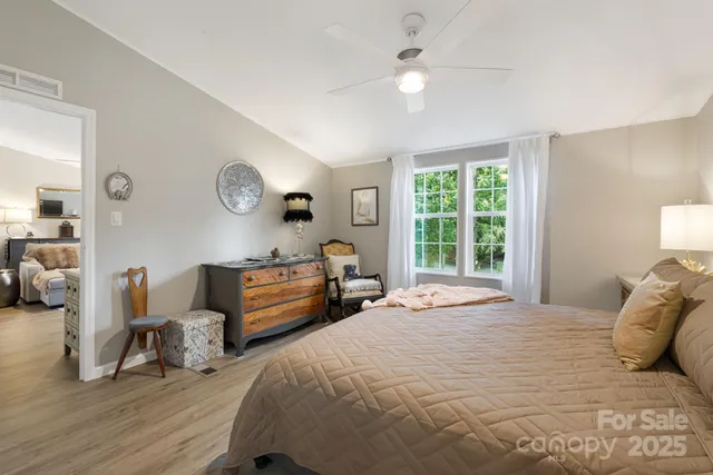 a bedroom with a bed and a large window