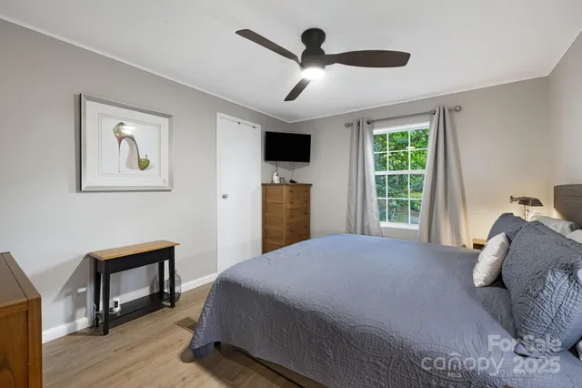 a bedroom with a large bed and a window