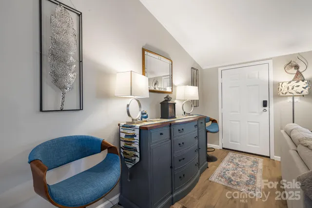 a room with furniture mirror and a lamp