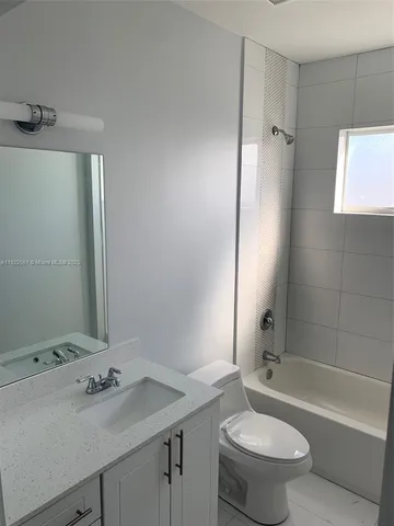 a bathroom with a sink toilet tub and shower