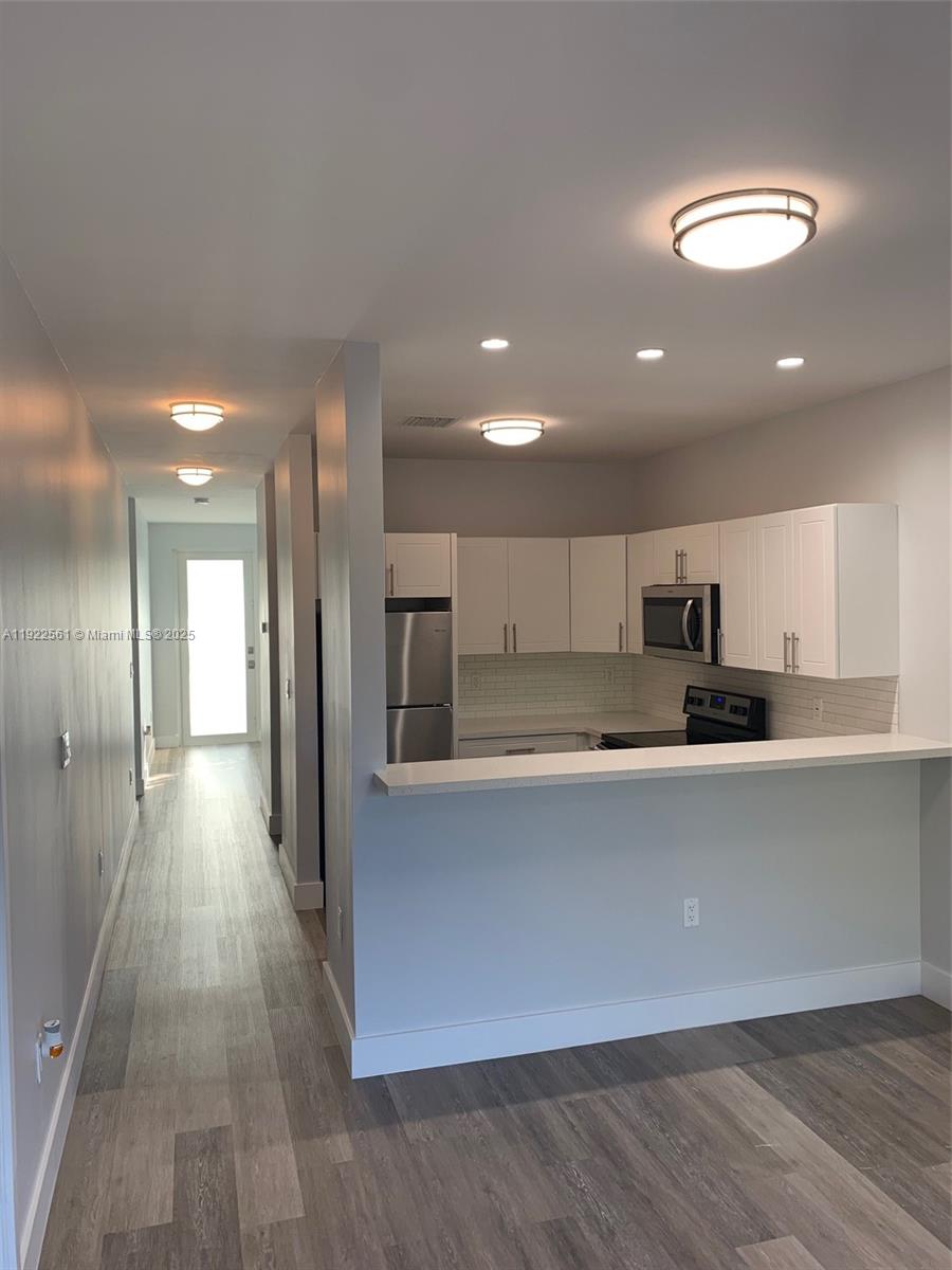 805 East 28th Street, Unit 805 Hialeah, FL 33013 - Photo 4 of 15 a view of kitchen with stainless steel appliances refrigerator sink and cabinets