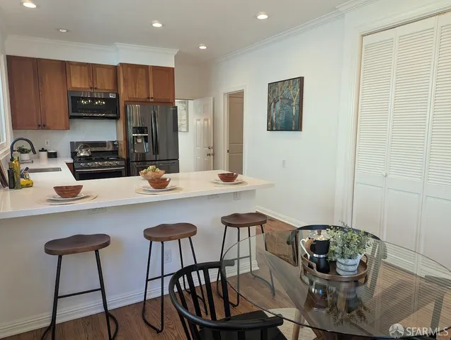 a kitchen with a table chairs stove and microwave