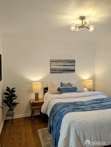 a bedroom with a bed and a chandelier