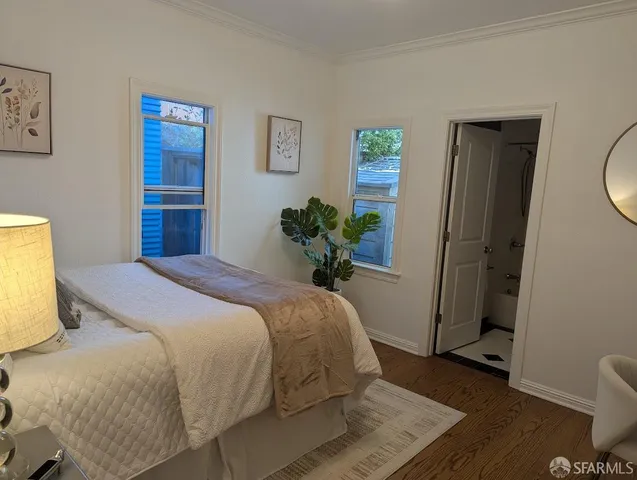 a bedroom with a bed and a potted plant