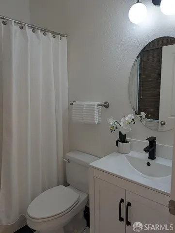 a bathroom with a sink toilet and mirror