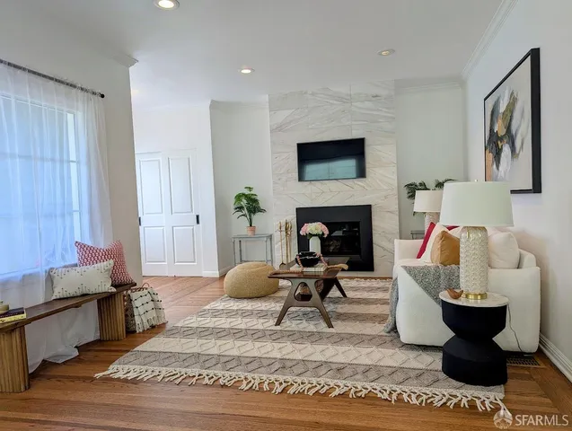 a living room with furniture a rug and a fireplace