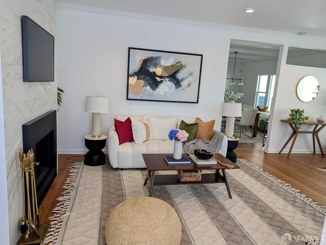 a living room with furniture a fireplace and a flat screen tv