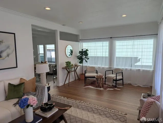 a living room with furniture and wooden floor
