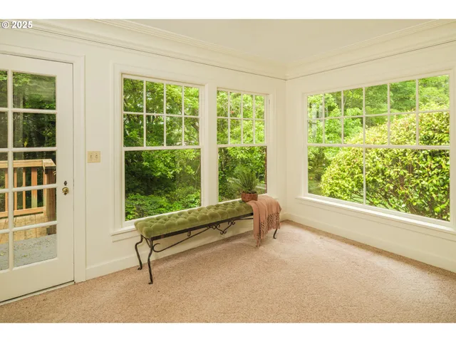 a living room with a floor to ceiling window and floor to ceiling windows