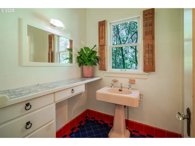 a bathroom with a sink and a window