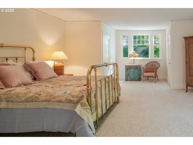 a bedroom with a bed and a night stand