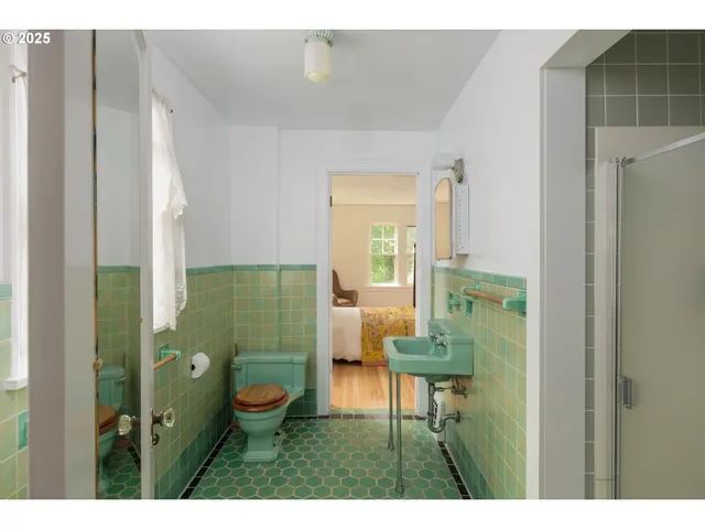 a bathroom with a sink shower and a mirror