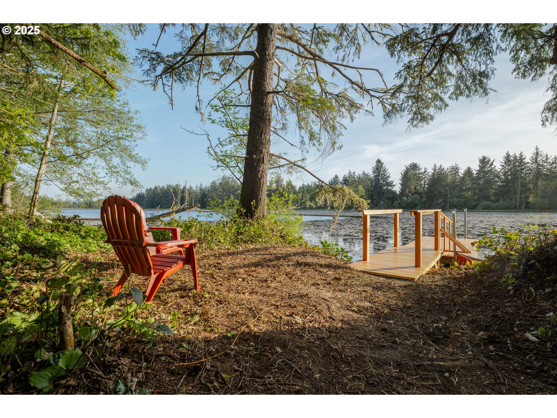 92216 Whiskey Road Warrenton, OR 97146 - Photo 41 of 48 a backyard of a house with table and chairs