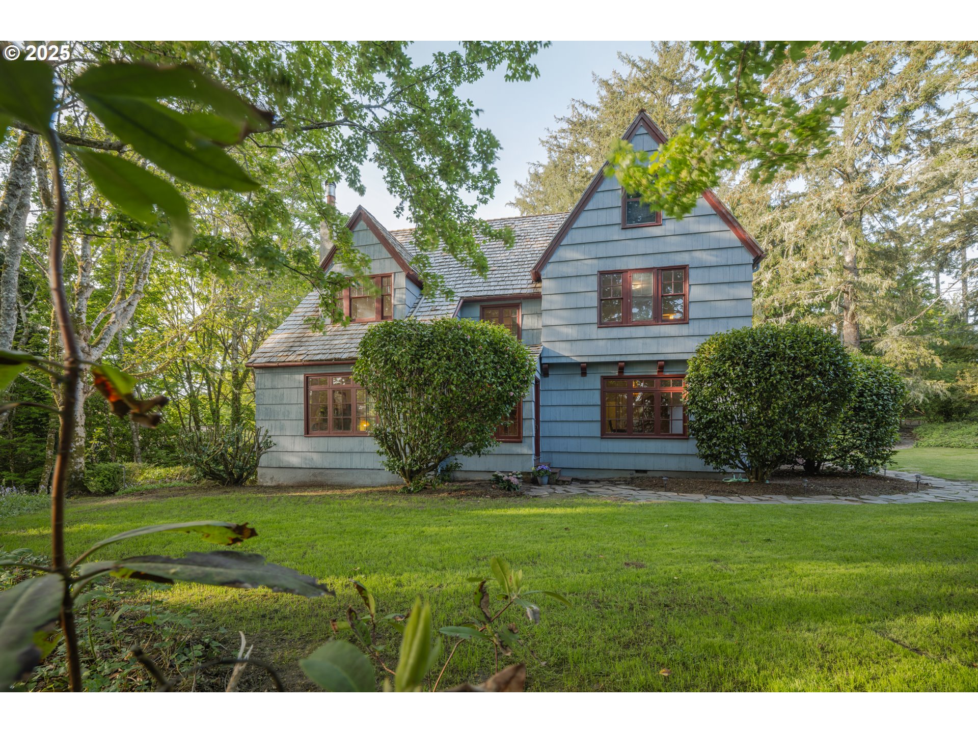 92216 Whiskey Road Warrenton, OR 97146 - Photo 45 of 48 a view of a yard in front of a house with plants and large tree