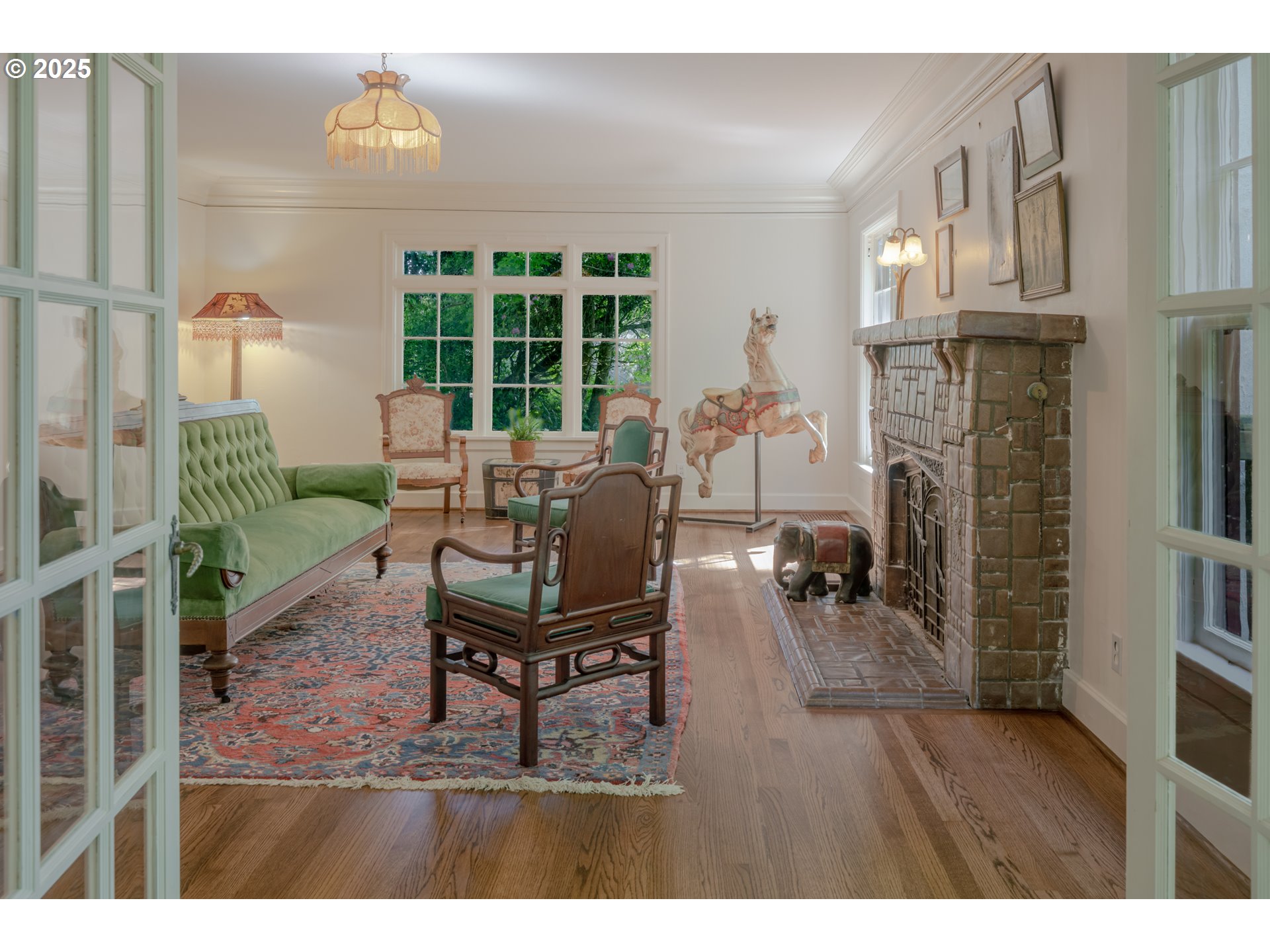 92216 Whiskey Road Warrenton, OR 97146 - Photo 10 of 48 a living room with furniture a fireplace and a floor to ceiling window