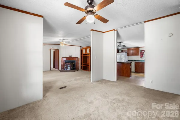 a view of a room with a kitchen and a sink