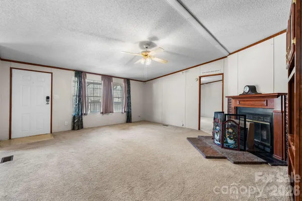 a view of an empty room with a fireplace