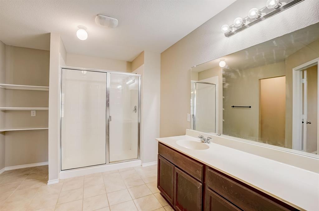 2113 Rubin Road Fate, TX 75189 - Photo 13 of 37 Full bathroom featuring vanity, a shower stall, and light tile patterned floors