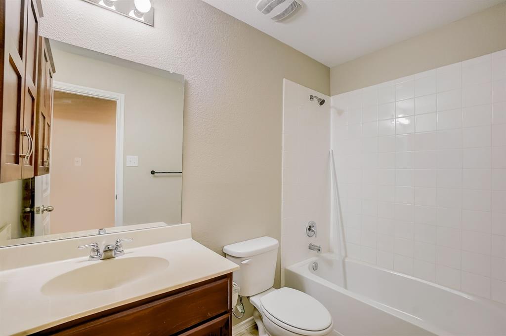 2113 Rubin Road Fate, TX 75189 - Photo 17 of 37 Bathroom with bathing tub / shower combination, vanity, and a textured wall