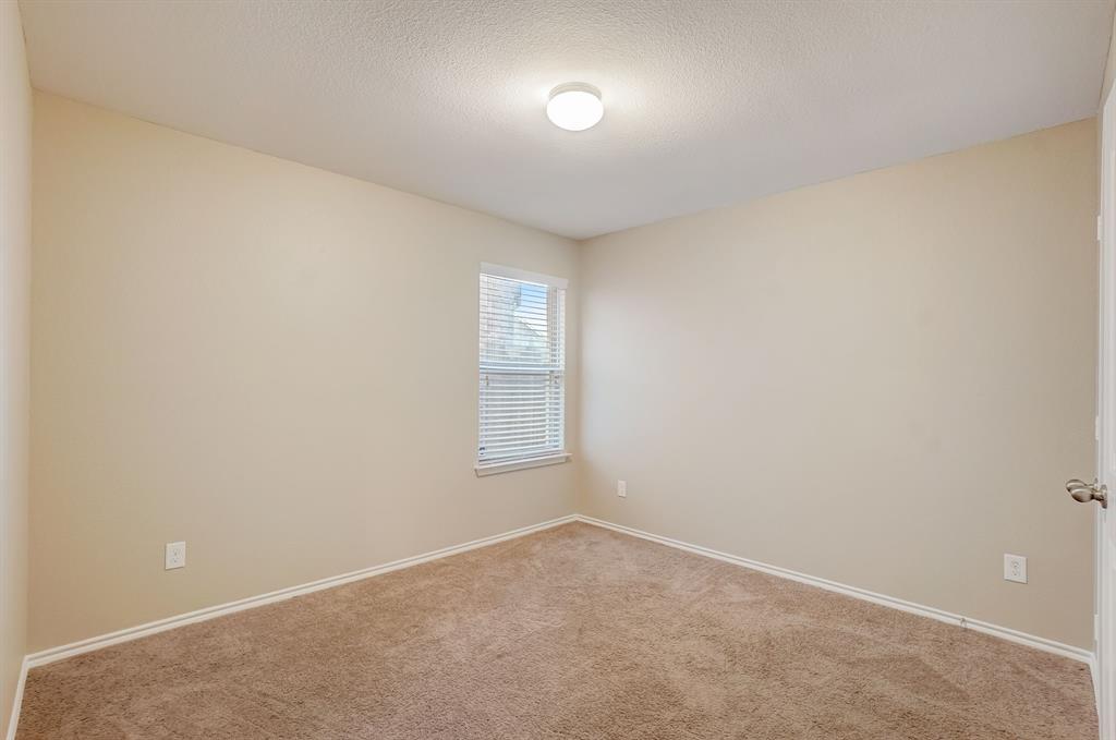 2113 Rubin Road Fate, TX 75189 - Photo 20 of 37 Carpeted empty room with a textured ceiling and baseboards