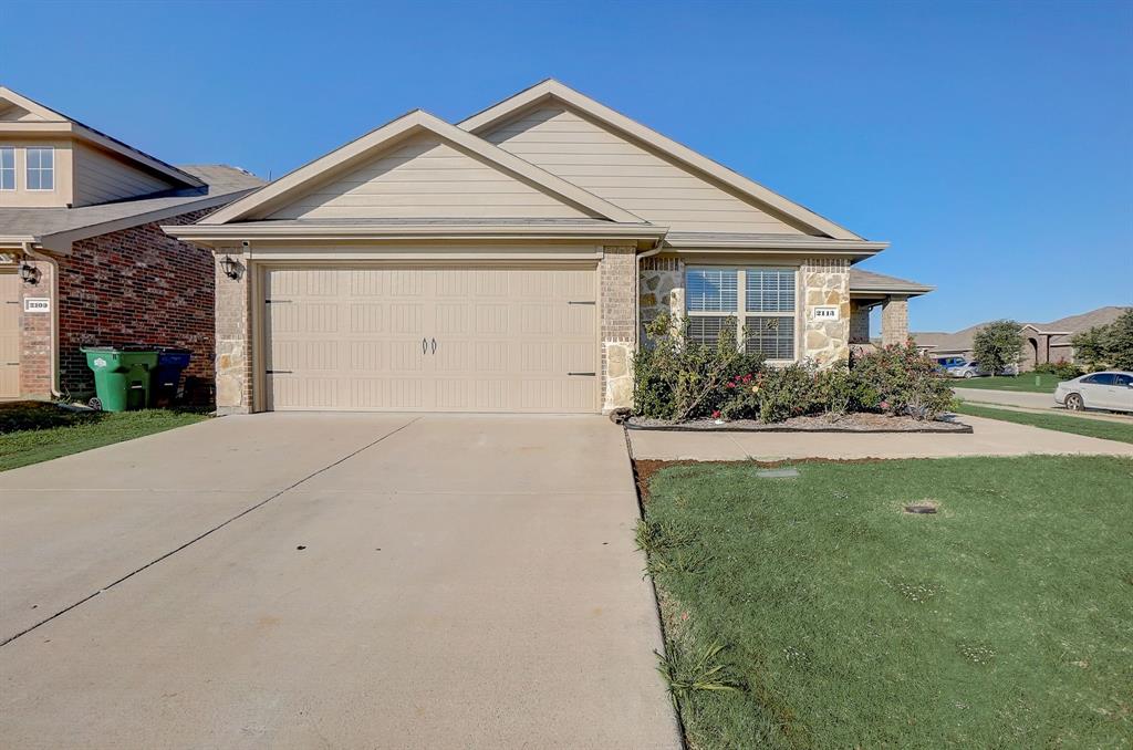 2113 Rubin Road Fate, TX 75189 - Photo 2 of 37 Single story home with concrete driveway, a front yard, stone siding, and an attached garage