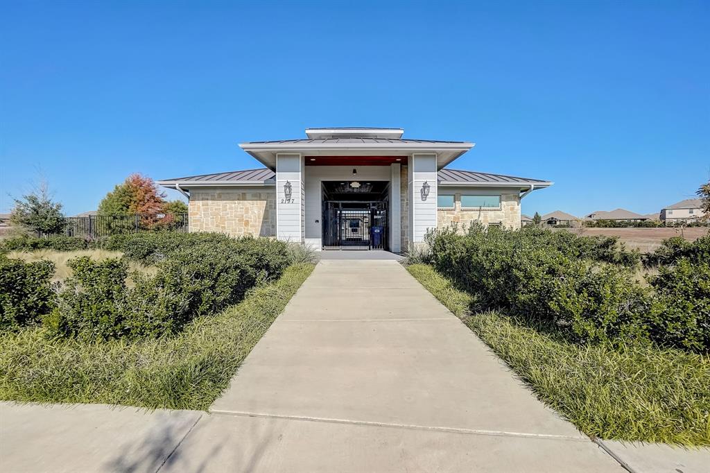 2113 Rubin Road Fate, TX 75189 - Photo 28 of 37 Property entrance featuring a standing seam roof, a metal roof, and stone siding