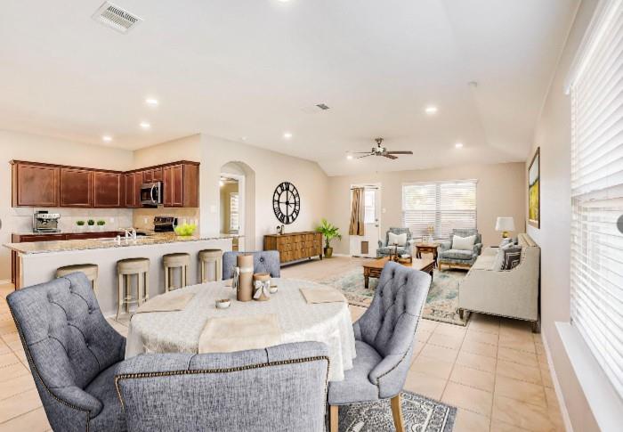 2113 Rubin Road Fate, TX 75189 - Photo 3 of 37 Dining room featuring arched walkways, recessed lighting, a ceiling fan, and light tile patterned flooring