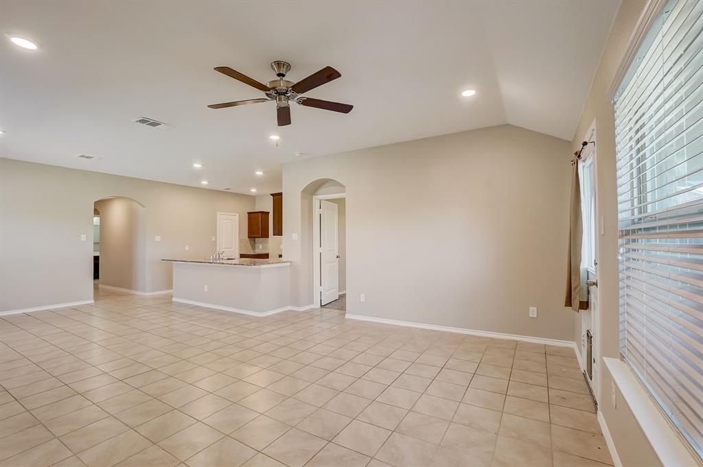 2113 Rubin Road Fate, TX 75189 - Photo 4 of 37 Unfurnished living room with recessed lighting, light tile patterned floors, vaulted ceiling, arched walkways, and ceiling fan