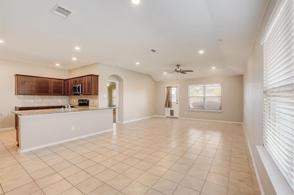 2113 Rubin Road Fate, TX 75189 - Photo 5 of 37 Unfurnished living room with arched walkways, light tile patterned flooring, recessed lighting, and ceiling fan