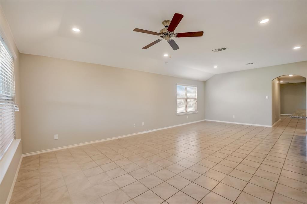 2113 Rubin Road Fate, TX 75189 - Photo 6 of 37 Spare room with arched walkways, light tile patterned floors, a ceiling fan, recessed lighting, and lofted ceiling