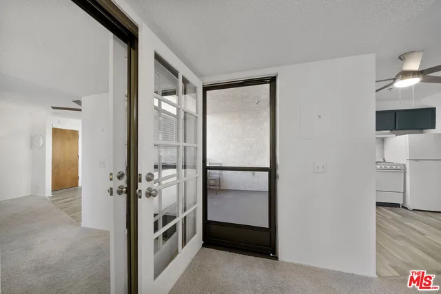 a balcony with furniture and view of potted plants