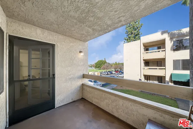 a front view of a house with a yard garden and outdoor seating