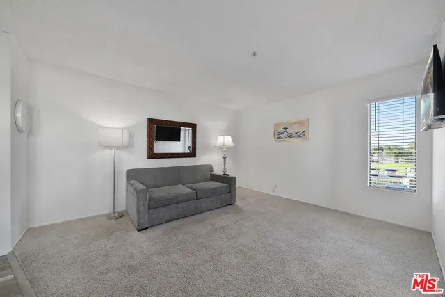 a living room with furniture and windows