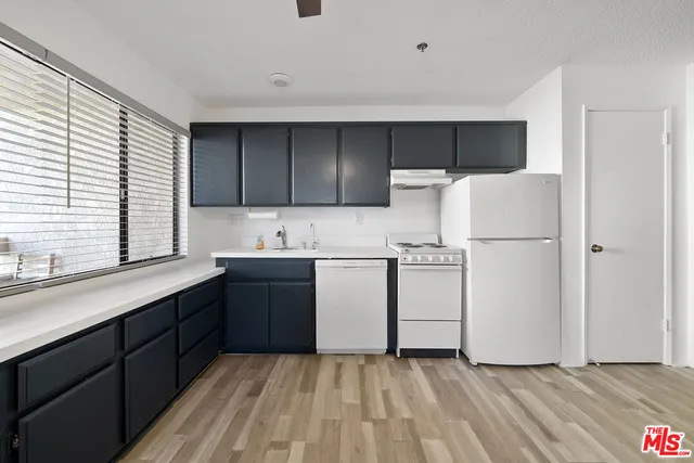 a bathroom with a sink a toilet a mirror and shower