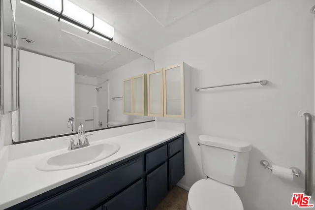 a bathroom with a shower curtain and a sink