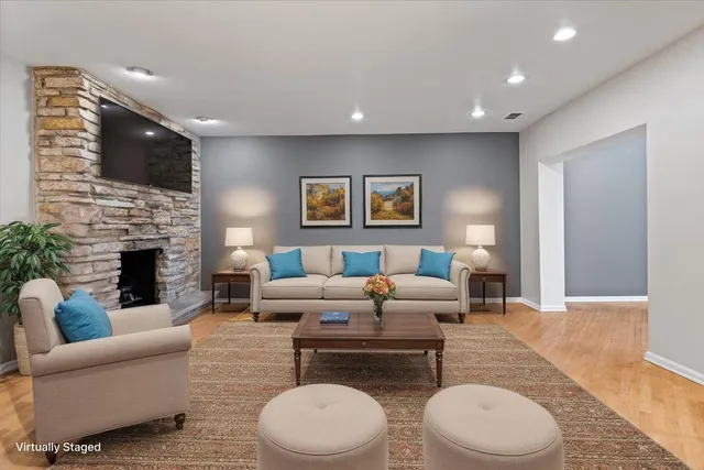 a living room with furniture a flat screen tv and a fireplace