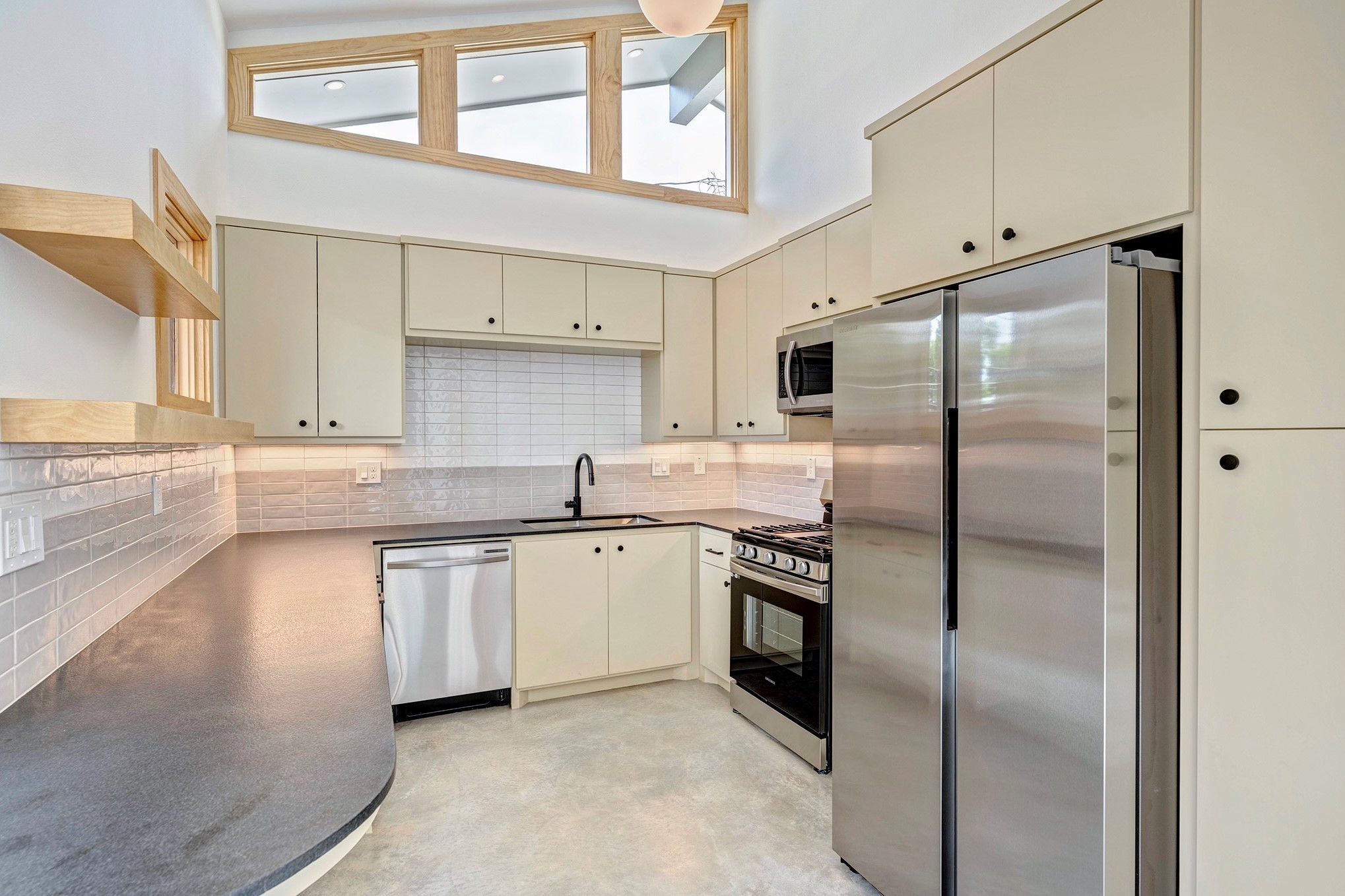 907 Kern Street, Unit B Houston, TX 77009 - Photo 4 of 18 a kitchen with stainless steel appliances granite countertop a refrigerator a stove and a sink
