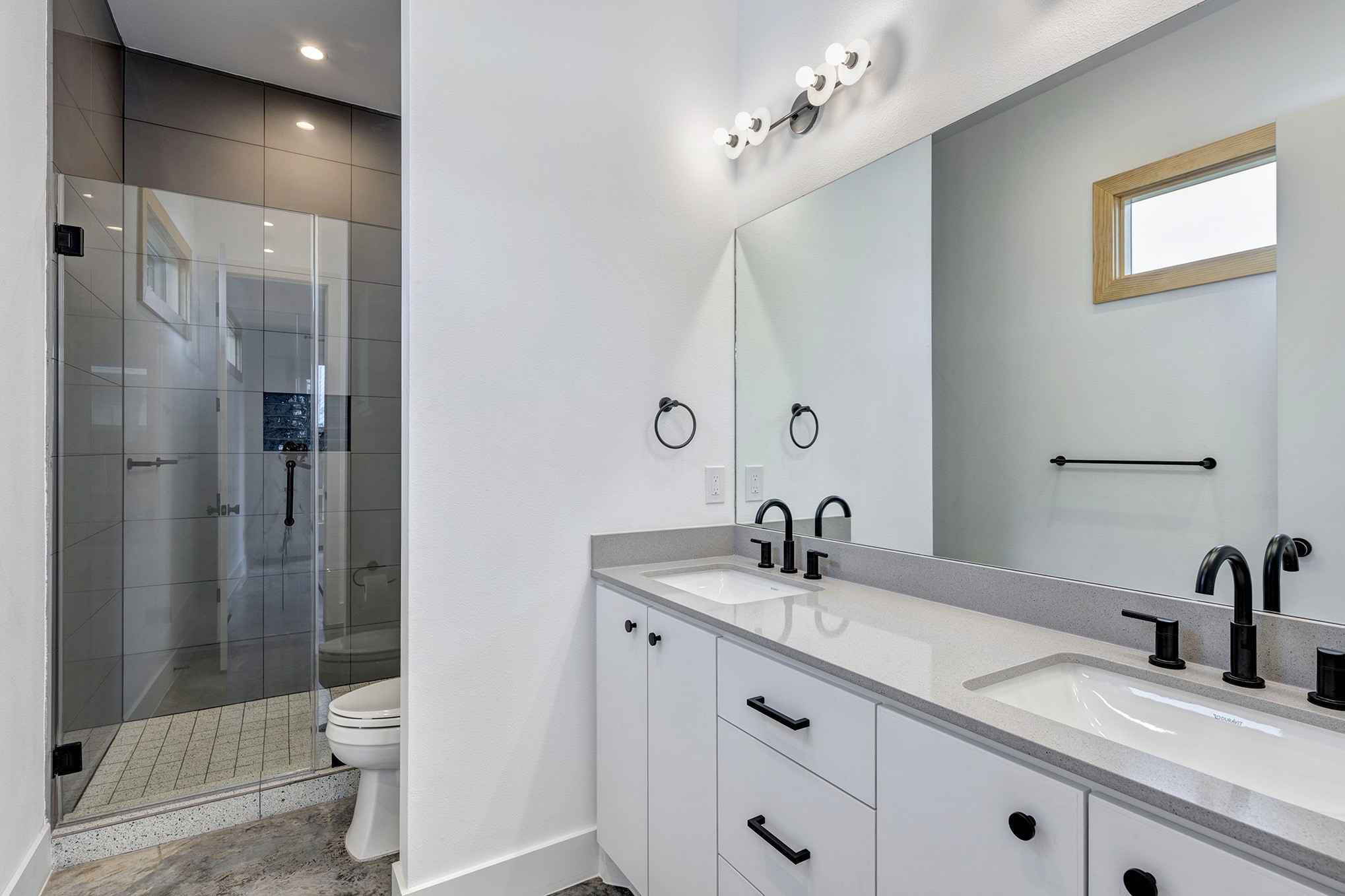 907 Kern Street, Unit B Houston, TX 77009 - Photo 8 of 18 a bathroom with a double vanity sink toilet and shower