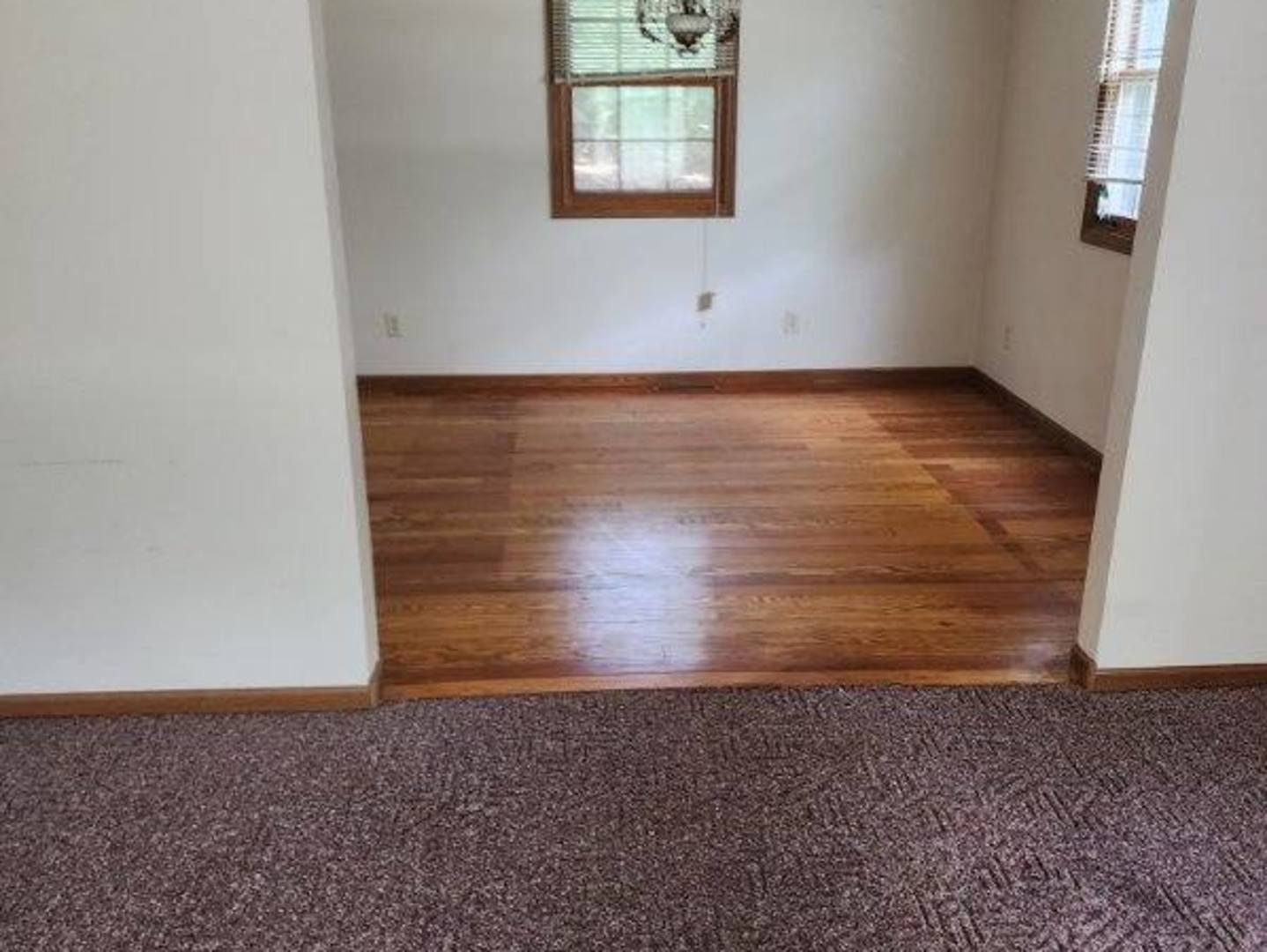 2871 East 777th Road Utica, IL 61373 - Photo 12 of 18 an empty room with wooden floor and windows