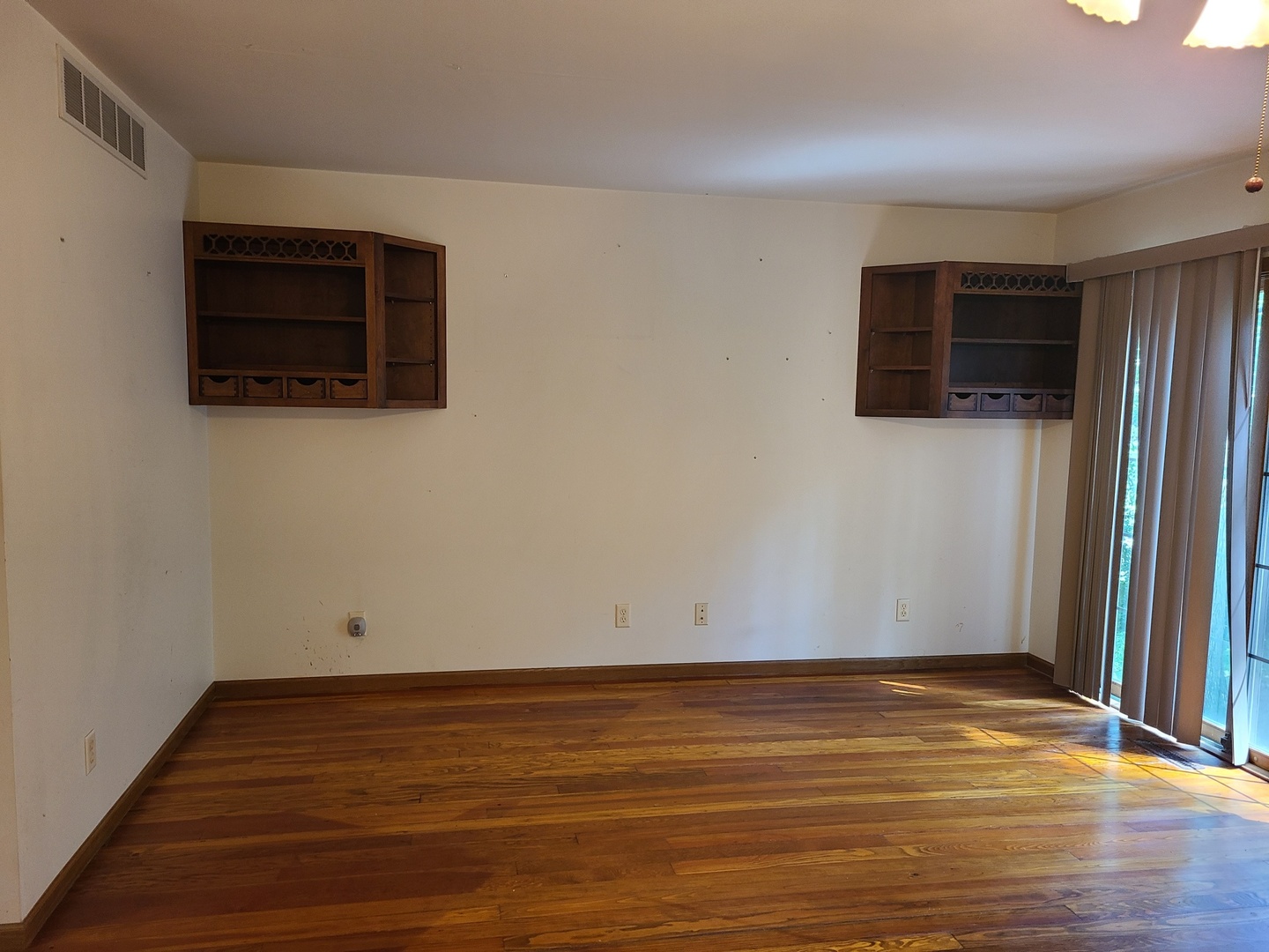 2871 East 777th Road Utica, IL 61373 - Photo 5 of 18 a view of an empty room with wooden floor and a window