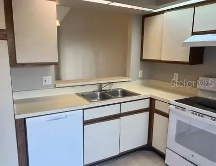 a kitchen with a sink cabinets and a microwave